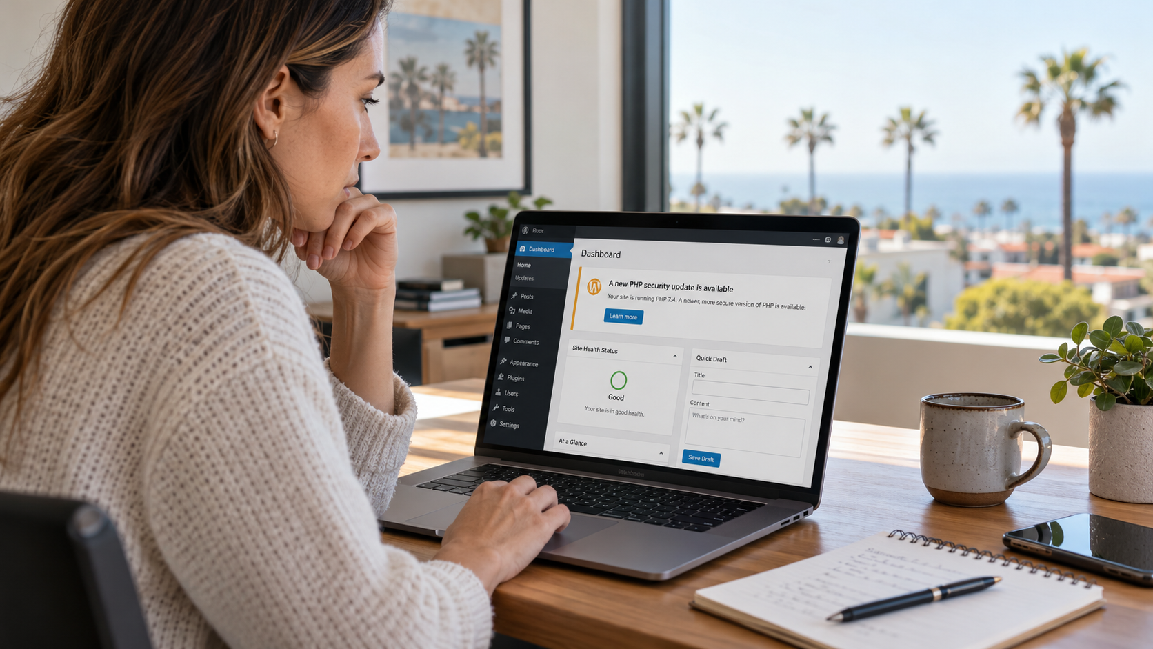 Business owner reviewing a WordPress website's PHP security update information on a laptop.